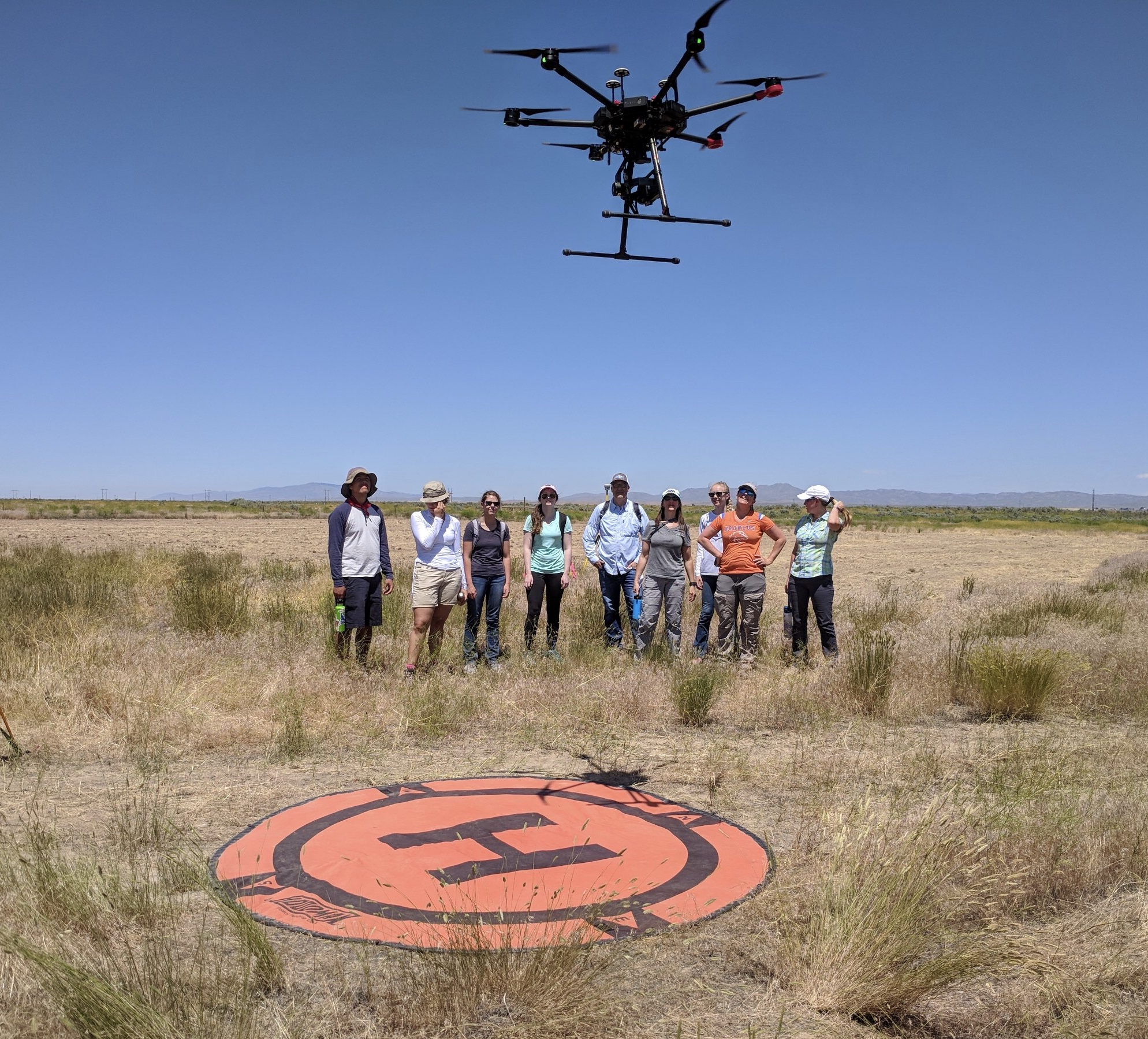 Research team from BSU, ISU and CI watch as drone launches. Photo credit, Jen Forbey.